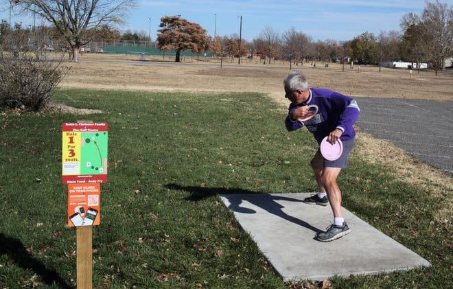 Rex Christner demonstrates different flight patterns of some of the various styles of discs that can be purchased to play disc golf. He's throwing from the longer of two tees for the first hole of the Keith Christner Family Disc Golf course at Rice Park, which is now open.