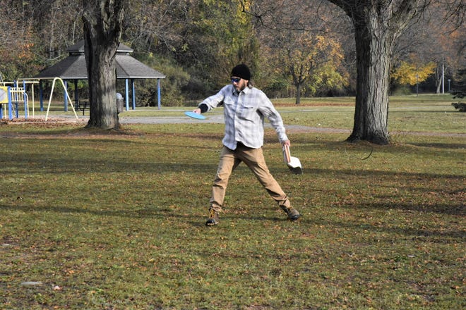Chad Curtis practices a drive on the disc golf course at Irving Park before league play on Sunday, Oct. 30, 2022. Curtis helped spearhead and design the course when it was installed in 2009, and said the disc golf community is excited more groups are invested in the park.